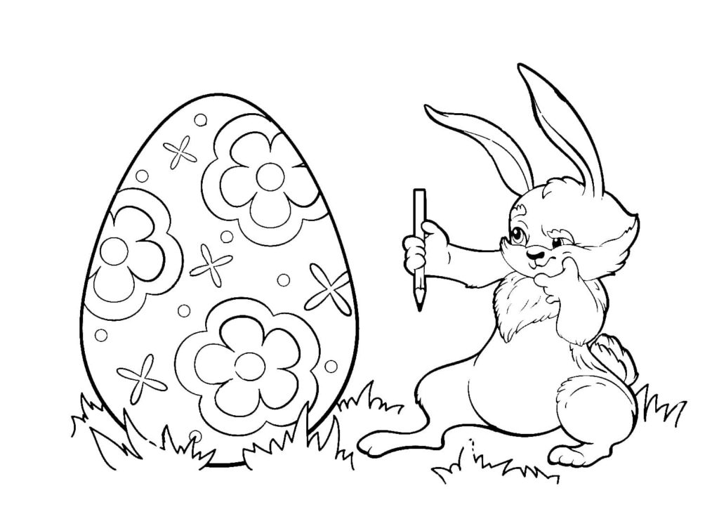 Coniglio che colora un uovo