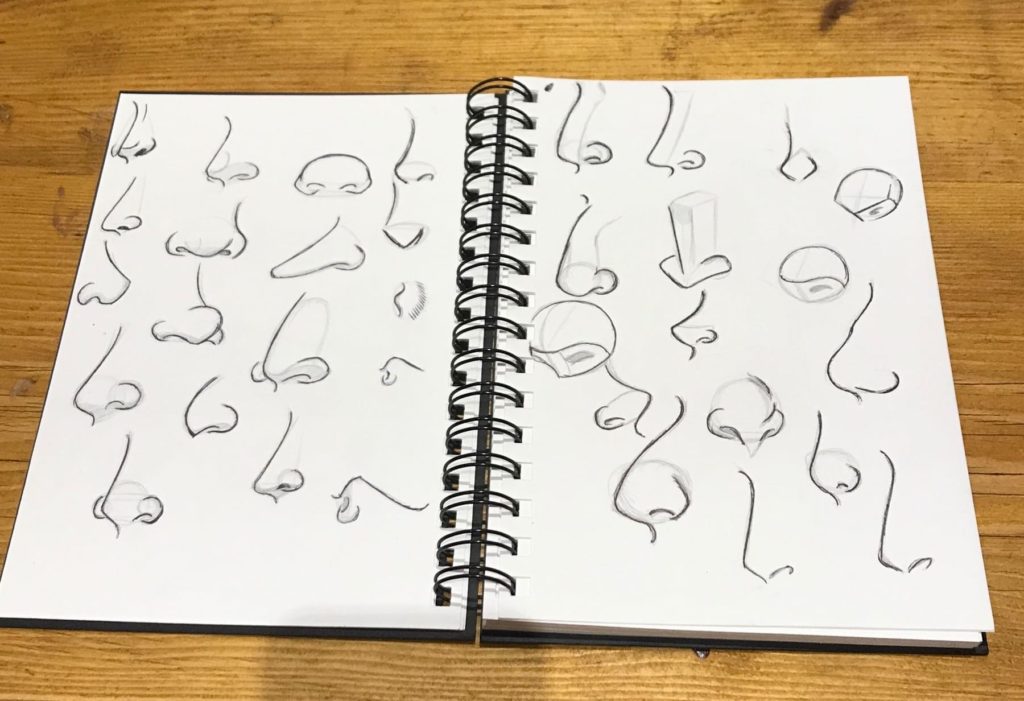 Nose drawing in a notebook